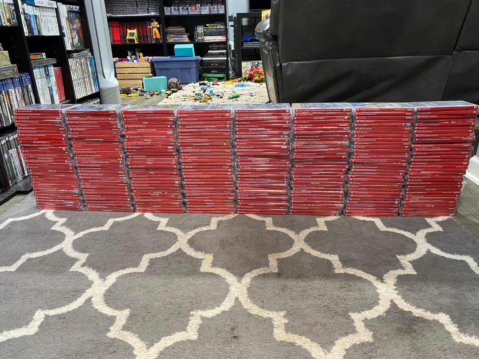 Hundreds of red-spined Nintendo Switch cases arranged in long rows across a rug