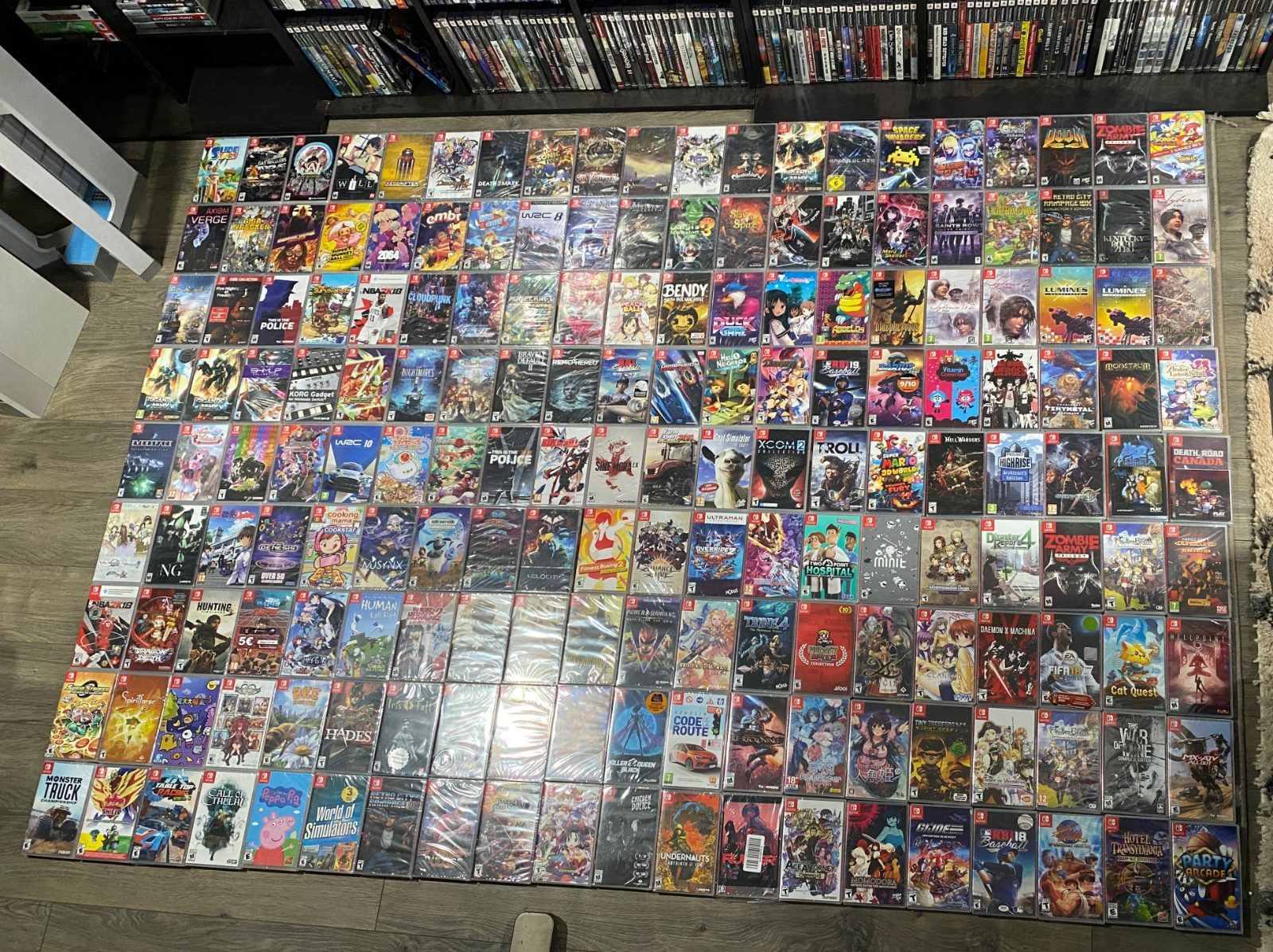 Sealed Nintendo Switch games arranged face-up in tightly packed rows on the floor